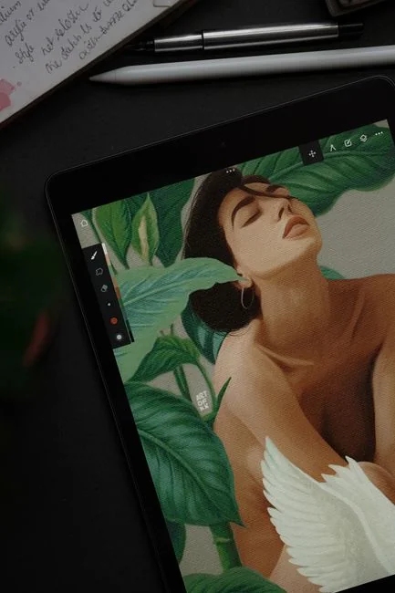 Woman using smartphone for online shopping with credit card in hand, festive background lighting.